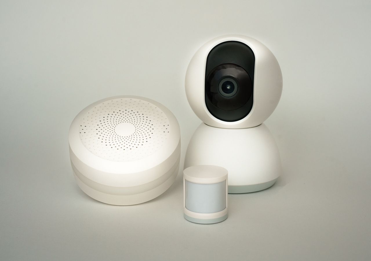The Art of Drawing Readers In: Your attractive post title goes here Modern smart home devices including a camera and sensors on a neutral background.